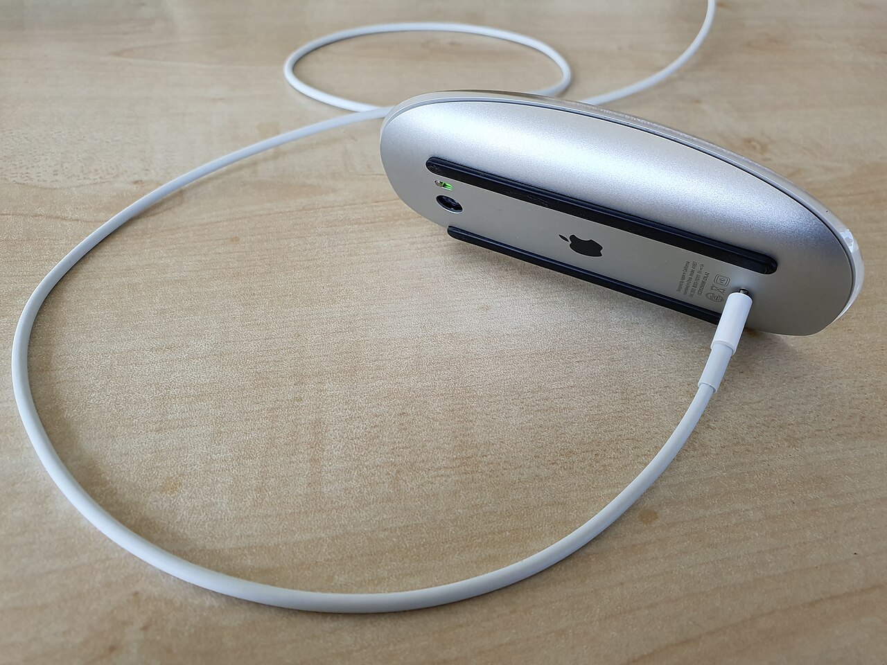 Magic Mouse 2 underside with a Lightning cable in the charging port